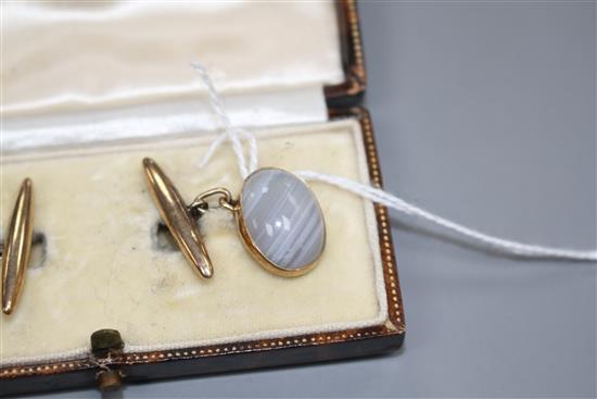 A pair of 9ct and cabochon grey banded agate set cufflinks, agate length 16mm, gross weight 7.7 grams.